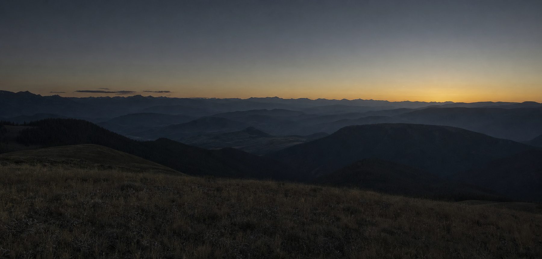 A Montana mountain ridge catching the last light at dusk
